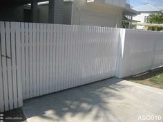 a white fence in front of a house