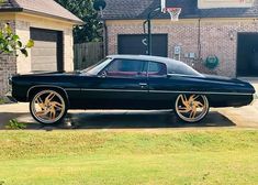 a black car parked in front of a house