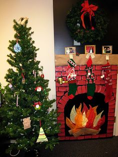 a christmas tree next to a fireplace with decorations on it