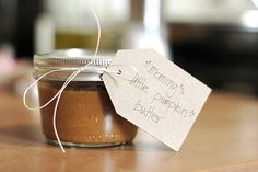 there is a jar with some food in it on the table and a tag that says mommy's little peanut butter cake mix