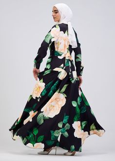 Elevate your wardrobe with this stunning floral print button-front maxi dress, crafted from durable crepe fabric for long-lasting comfort and elegance. The soft black base is adorned with a vibrant floral pattern, making it a standout piece for any occasion. Designed with a modest fit, this dress features a belted waist and tiered skirt, providing a flattering silhouette that flows gracefully with every movement. The button-front design adds a touch of sophistication, while the long sleeves ensu Buttoned Maxi Dress For Garden Party, Black Maxi Dress With Button Closure, Black Floral Print Floor-length Maxi Dress, Black Floral Maxi Dress For Garden Party, Modest Black Floral Print Maxi Dress, Modest Black Maxi Dress With Floral Print, Black Floral Print Maxi Dress, Spring Black Maxi Dress With Button Closure, Black Maxi Dress With Button Closure For Spring