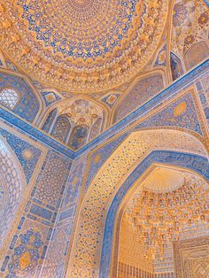 an ornate ceiling in the middle of a building with blue and yellow tiles on it