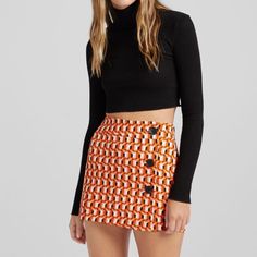 Small Never Worn Patterned Bershka Skirt Trendy Orange Skirt For Fall, Black Retro Mini Skirt For Fall, Chic Fitted Orange Mini Skirt, Fitted Orange Skort, Chic Orange Mini Skort, Chic Orange Lined Mini Skirt, Chic Orange Mini Skirt With Lining, Orange Fitted Retro Mini Skirt, Fitted Retro Orange Mini Skirt