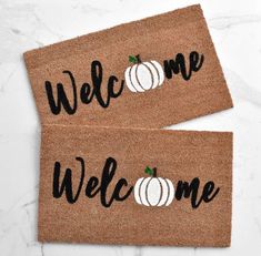 two welcome mats with pumpkins on them