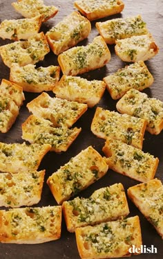 several pieces of bread with cheese and herbs on them