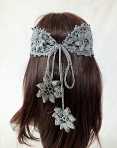 a close up of a woman's head wearing a crochet headband