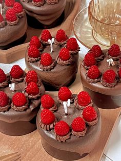 chocolate heart shaped cakes with raspberries on top are ready to be cut and served