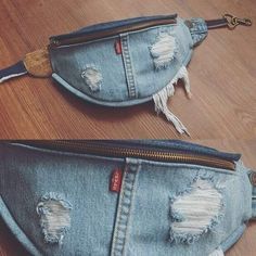 two denim purses with holes and zippers on the inside are sitting on a wooden floor