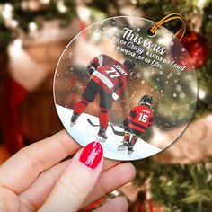 a christmas ornament with an image of a hockey player on it and the words, this is us