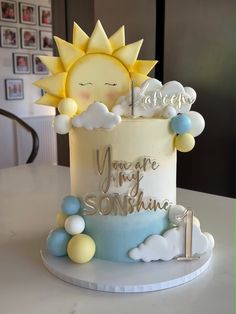 there is a cake that says you're my sunshine on the top and clouds around it