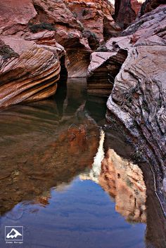 the water is clear and still moving through the canyons as it reflects in the rock