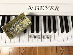 a close up of a piano with an object on it's side and the words a - geyer above it