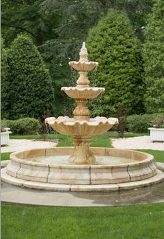 a water fountain in the middle of a park