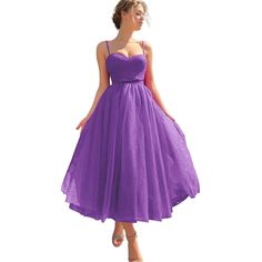 a woman in a purple dress is posing for the camera