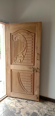 an open wooden door with intricate carvings on the front and side panels inlays