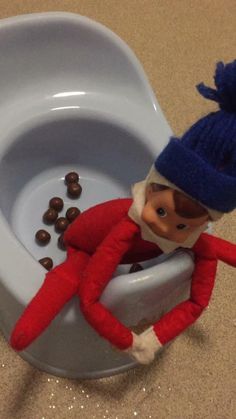 an elf is sitting in the toilet bowl