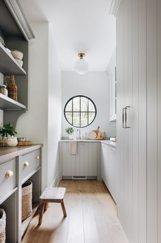 Light gray cabinetry bounces the natural light beautifully in this butler's pantry.