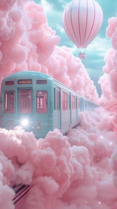 a train traveling through clouds with hot air balloons in the sky