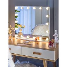 a dressing table with lights on it and a fur rug in front of the mirror