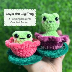 two little crocheted frog dolls sitting on top of each other with the caption lagua the lily frog