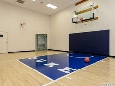 an indoor basketball court with blue and white flooring