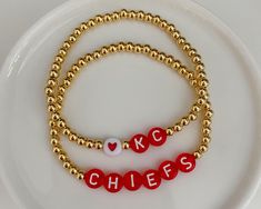 Kansas City Chiefs bracelets. Sold separately, but can be purchased as a set. Made with seed beads and gold accent beads. - - SIZING - - Every piece is made just for you! Our standard size fits a 6 inch wrist (measures 6.5 inches total length), but can be adjusted upon request. Please leave your desired size in the 'Notes' section upon checkout. Gold Heishi Beads Bracelets For Friendship, Gold Heishi Beads Bracelets As Gift, Gold Heishi Beads Bracelet Gift, Gold Heishi Beads Beaded Bracelets Gift, Gold Heishi Beads For Gift, Gold Charm Bracelet With Colorful Beads For Friendship, Gift Stretch Bracelet With Gold And Heishi Beads, Gold And Heishi Beads Stretch Bracelet Gift, Gold Heishi Beads Name Bracelet As Gift