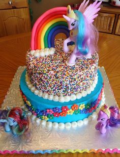 a cake with sprinkles and a pony on top