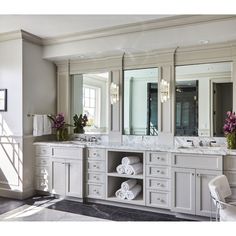 a large bathroom with double sinks and mirrors