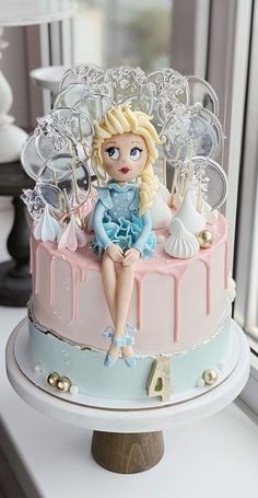 there is a cake with a doll sitting on it