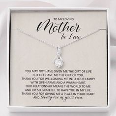 a mother's necklace in a box with the poem to my loving mother on it