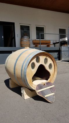 a wooden barrel shaped like a dog house