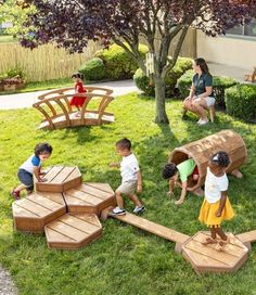 children playing in the yard with wooden benches and play equipment for adults to sit on