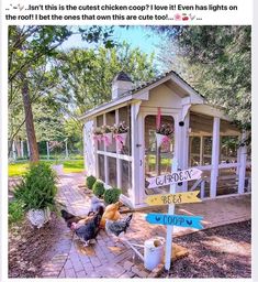 two chickens are standing in front of a chicken coop with a sign pointing to the right