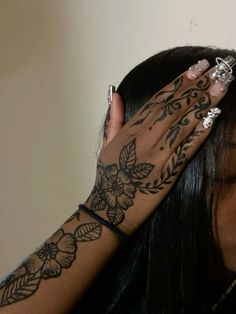 a woman with tattoos on her arm and hand