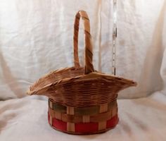 a wicker basket sitting on top of a white sheet