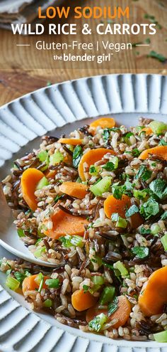 a white plate topped with wild rice and carrots