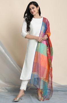 Trendia brings you this white suit set for women by the brand Janasya. The white kurta has a boat neck. The Kurti has 3/4th sleeves. The Indian kurta Set is in poly silk. The bottom is white pants & have an elasticated closure. The dupatta is in art silk with golden border and tassels. Check out photos of the kurta set for a more detailed look. KurtaFabric - Poly SilkColour - WhiteNeck - BoatSleeves- 3/4th Sleeves Pants Colour- Black golden Closure- Elasticated Fabric - Poly Silk DupattaFabric Multicolor Dupatta, Sleeveless Kurti, Kurta Palazzo Set, Readymade Salwar Kameez, Dresses Traditional, Indian Kurta, White Kurta, Palazzo Set, Anarkali Kurta