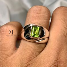 Ring Details - Natural Peridot - Main Stone Size: 8.00x6.00 mm Approximate - Ring Front width: 12.5mm - Band Width: 5.6mm - Band Thickness: 2.00mm - Gross Weight: 12.00 grams - Handmade Ring - Hand Engraved Design - Sterling Silver 925  - Hallmarked - Dimensions and Weight Depends on Variations in Sizes. - Available in all Sizes ( Please make sure about your ring sizes) - DM for Customizations NOTE: - Our Products are Made to Order According to Customer's Expectations So It May Take Some Time. B Green Sterling Silver Solitaire Ring, Green Solitaire Sterling Silver Ring, Emerald Cut Peridot Ring For May Birthstone, Formal Lime Green Rings With Center Stone, Classic Solitaire Peridot Jewelry, Classic Peridot Solitaire Jewelry, Anniversary Rings With Peridot Gemstones, Sterling Silver Rings With Lime Green Accent Stones, Lime Green Sterling Silver Rings With Accent Stones