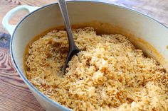 a large pot filled with rice on top of a wooden table