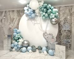 an elephant balloon arch with blue and silver balloons