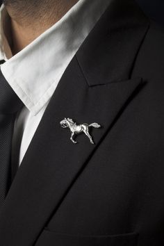 "If he is a horse lover or a horse racing fan, he will adore my galloping horse lapel pin. The hand carving and detailing on this pin are impeccable, entirely made of 925 sterling silver. A light brushing of the silver and a black oxide finish that sinks into every crevice helps to give it depth and dimension. ABOUT THIS LAPEL PIN ➼ Handmade from solid 925 sterling silver. ➼ Horse is 5 cm long. ➼ Silver butterfly clutch back. ➼ Comes in a handsome black alligator print gift box, ready for giving Luxury Men's Brooches As Gift, Luxury Men's Wedding Lapel Pin, Luxury Men's Brooch Jewelry, Luxury Men's Jewelry Brooch, Cheap Men's Brooches For Gifts, Cheap Men's Brooches Gift, Broches Jewelry Men, Luxury Sterling Silver Bolo Tie For Gift, Hands Jewelry