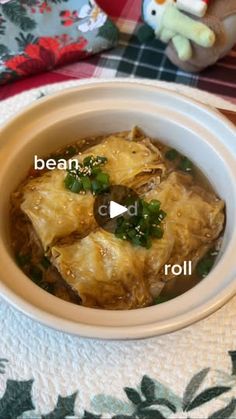 a white bowl filled with food on top of a table