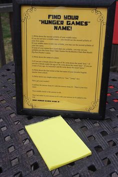 a yellow piece of paper sitting on top of a table next to a framed sign