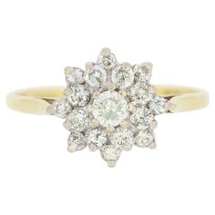 an antique diamond cluster ring in yellow gold