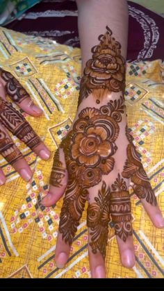 the hands are decorated with henna designs