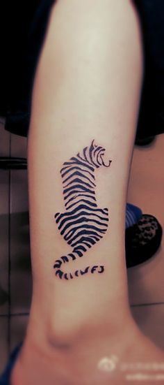 a person with a zebra tattoo on their leg