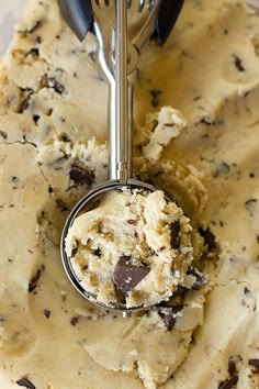 a scoop of ice cream with chocolate chips on it and a fork in the bowl