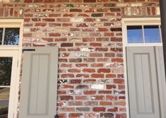 a brick building with two white doors and windows