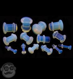 an assortment of blue and white glass plugs on a black background with text overlay