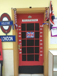 a red door with british flags on it and the words telephone to london written in english